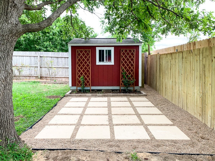 This pea gravel patio with large pavers is a beautiful, DIY-friendly project! Learn all the details on how to lay pavers, how to install a pea gravel patio, and more!